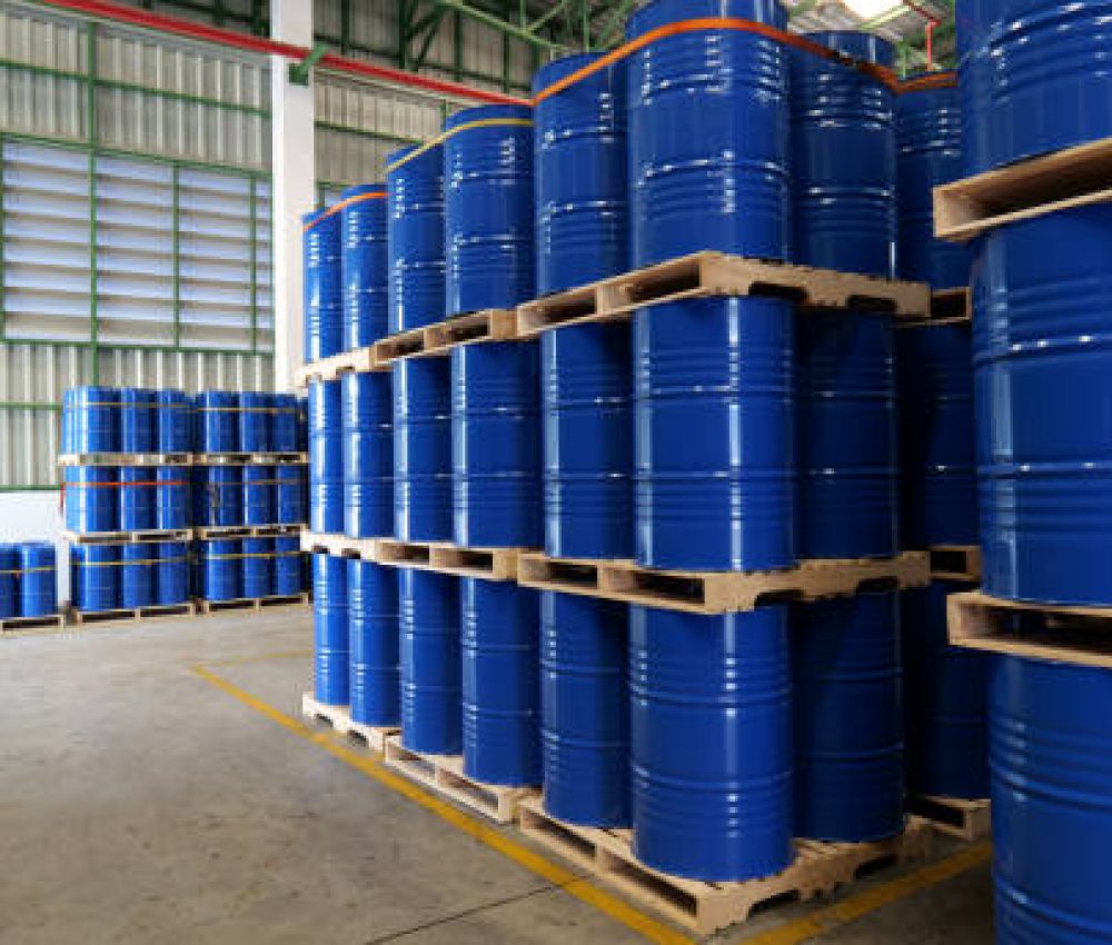 A blue barrel In the warehouse, 200-liter chemical barrels are arranged on wooden pallets and waiting for delivery. Transportation technology, petroleum industry, and chemical industry concepts